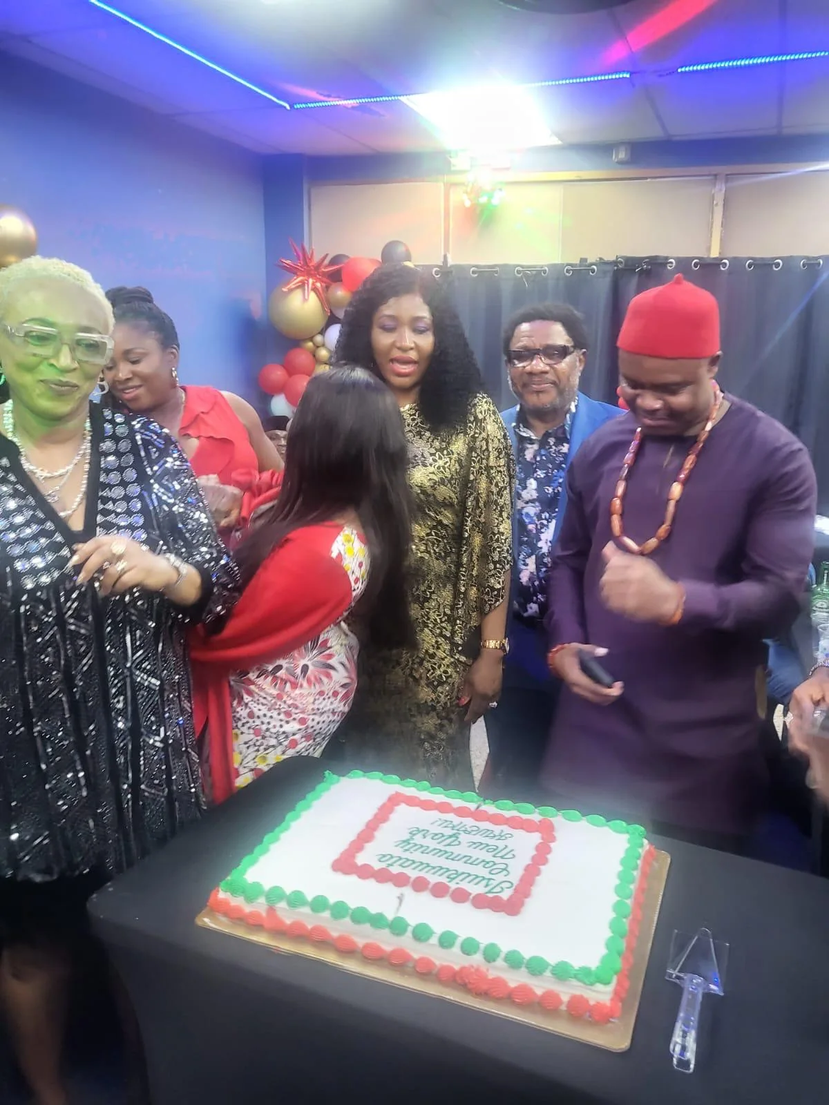 Community members gathered around a celebration table