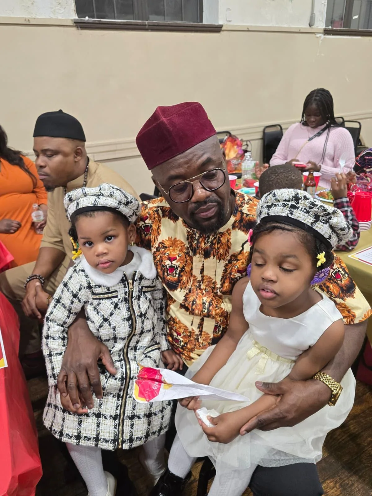 Family members in traditional clothing at a community gathering